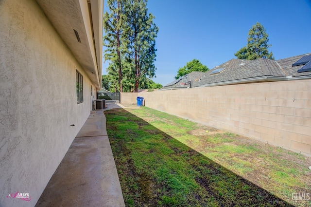 view of yard featuring central AC unit and a fenced backyard