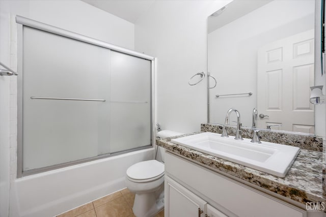 10002 Riata Ln, Bakersfield, CA 93306 - bathroom with toilet, tile patterned floors, vanity, and shower / bath combination with glass door