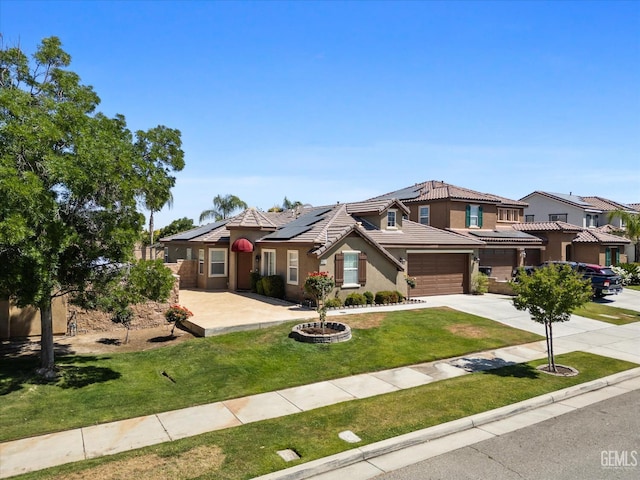 10002 Riata Ln, Bakersfield, CA 93306 - view of front of property featuring concrete driveway, solar panels, a front yard, a tiled roof, and a garage