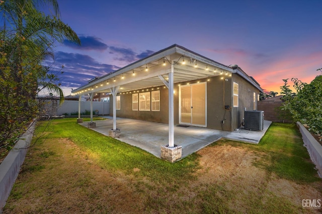 10002 Riata Ln, Bakersfield, CA 93306 - rear view of house featuring a patio, stucco siding, and central AC unit