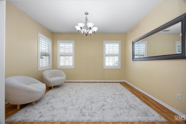 10002 Riata Ln, Bakersfield, CA 93306 - sitting room featuring a chandelier, wood finished floors, and baseboards