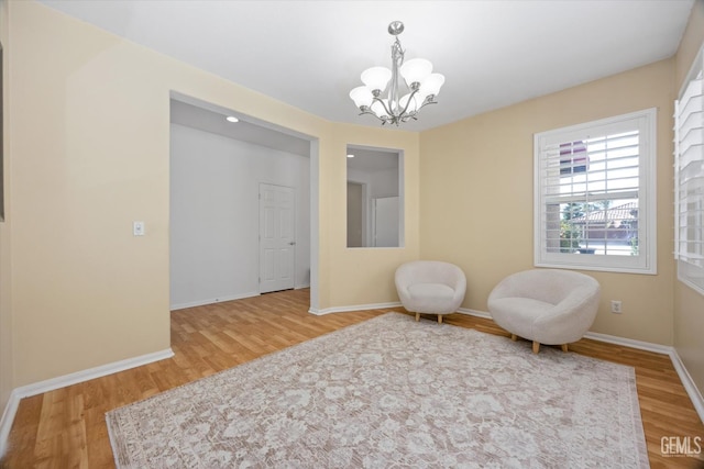 10002 Riata Ln, Bakersfield, CA 93306 - sitting room with wood finished floors, a chandelier, and baseboards