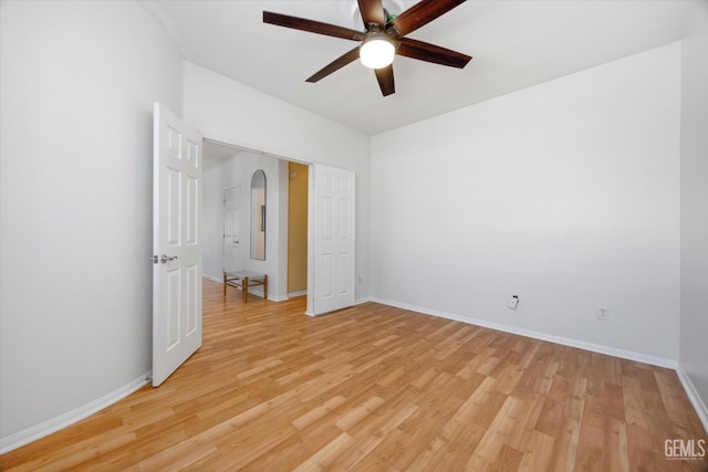 10002 Riata Ln, Bakersfield, CA 93306 - unfurnished bedroom with light wood-style flooring, baseboards, ceiling fan, and arched walkways