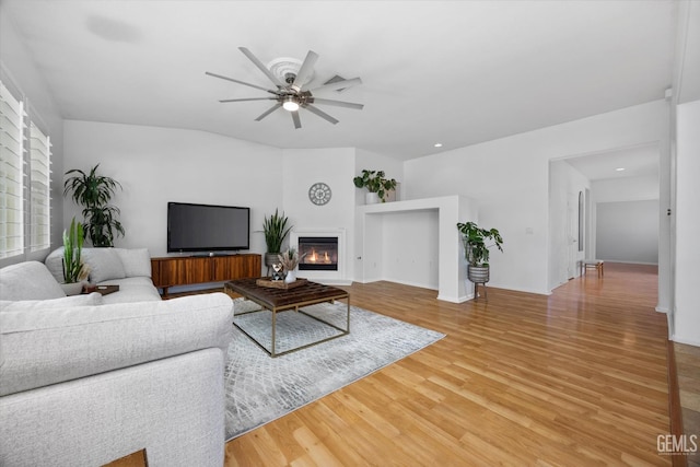10002 Riata Ln, Bakersfield, CA 93306 - living area with light wood-style floors, a ceiling fan, a glass covered fireplace, and recessed lighting