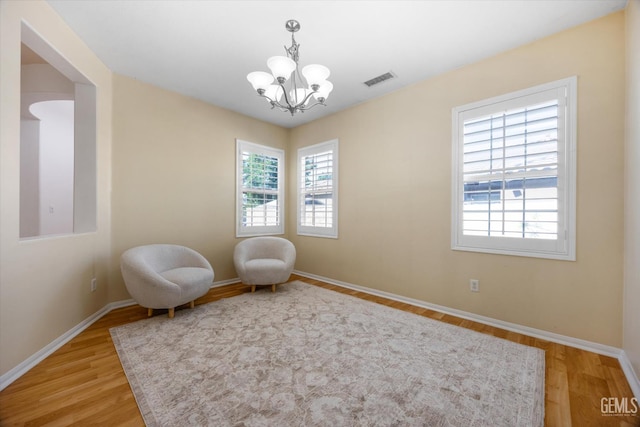 10002 Riata Ln, Bakersfield, CA 93306 - living area featuring healthy amount of natural light, a chandelier, light wood-type flooring, and baseboards