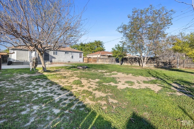 view of yard with a patio area and a fenced backyard