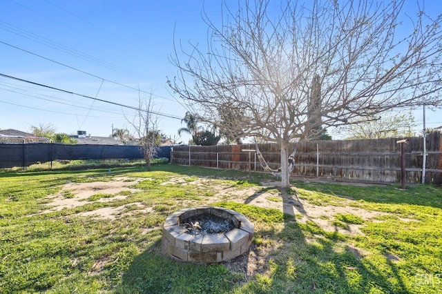 view of yard featuring an outdoor fire pit and a fenced backyard