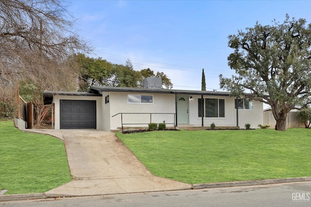 ranch-style house featuring a garage and a front lawn