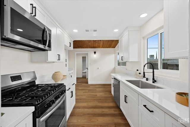 kitchen featuring white cabinetry, sink, and appliances with stainless steel finishes