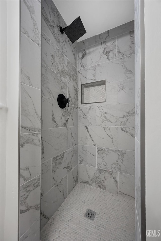 bathroom with tiled shower