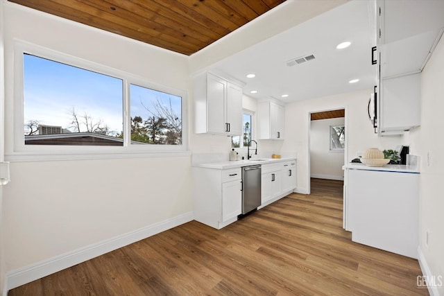 kitchen featuring white cabinetry, dishwasher, sink, and light hardwood / wood-style flooring