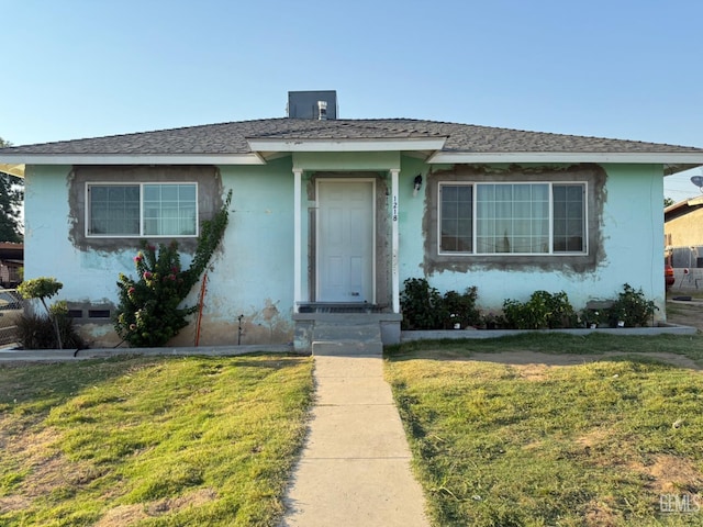 1218 Water St 0, Bakersfield, CA 93305 - view of front facade featuring a front yard, a shingled roof, and stucco siding