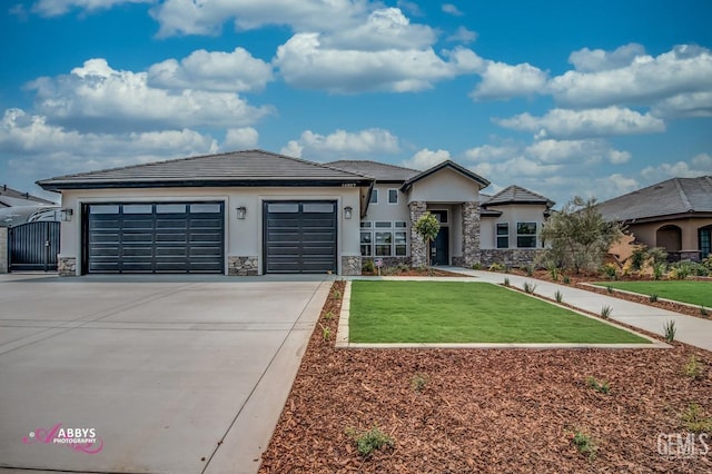 prairie-style home with a garage and a front lawn