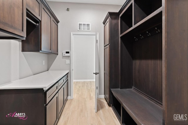 mudroom with light hardwood / wood-style floors