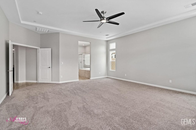 unfurnished bedroom with ensuite bath, ceiling fan, and carpet