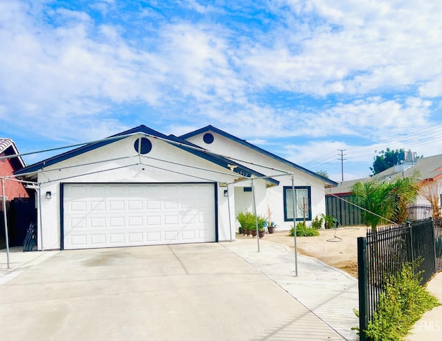 ranch-style house featuring fence, driveway, an attached garage, and stucco siding