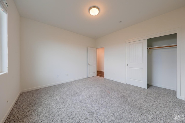 unfurnished bedroom with a closet and carpet