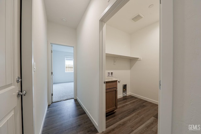 clothes washing area featuring washer hookup and dark hardwood / wood-style floors