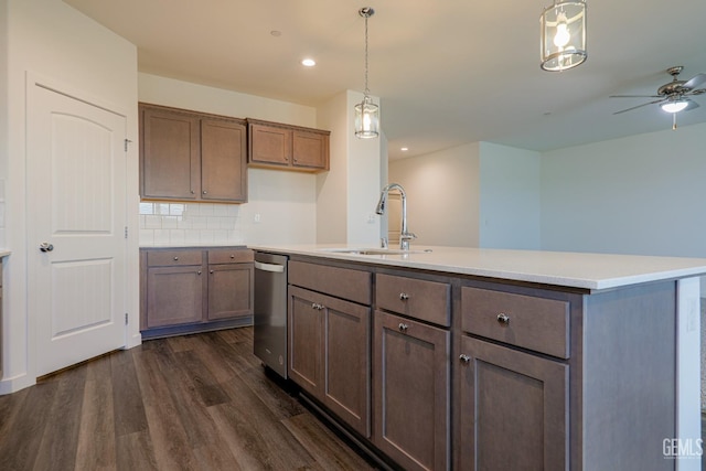 kitchen featuring decorative backsplash, sink, a center island with sink, dishwasher, and hanging light fixtures