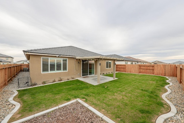 rear view of house with a patio and a lawn