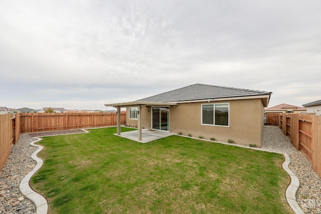 back of property featuring a yard and a patio