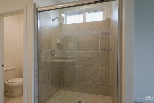 bathroom featuring toilet and walk in shower