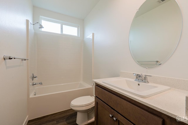 full bathroom featuring hardwood / wood-style floors, vanity, tub / shower combination, and toilet