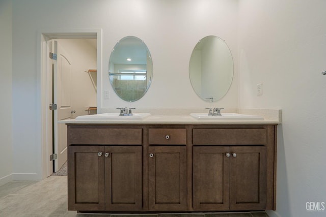 bathroom featuring tile patterned flooring and vanity