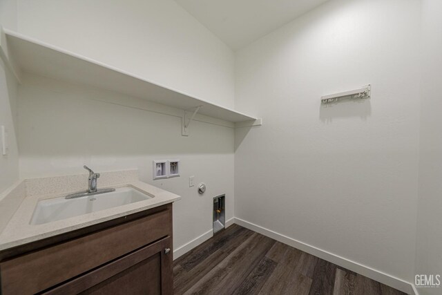 laundry area with cabinets, hookup for a washing machine, sink, dark hardwood / wood-style floors, and hookup for a gas dryer