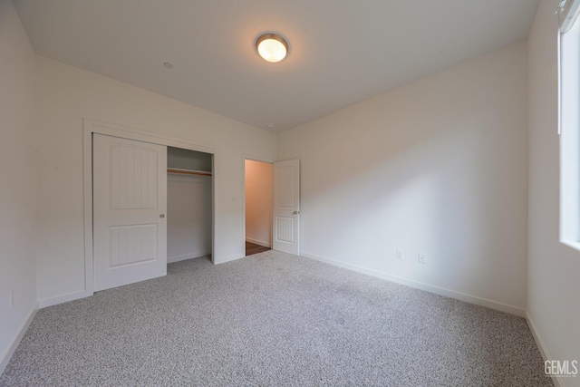 unfurnished bedroom with carpet and a closet