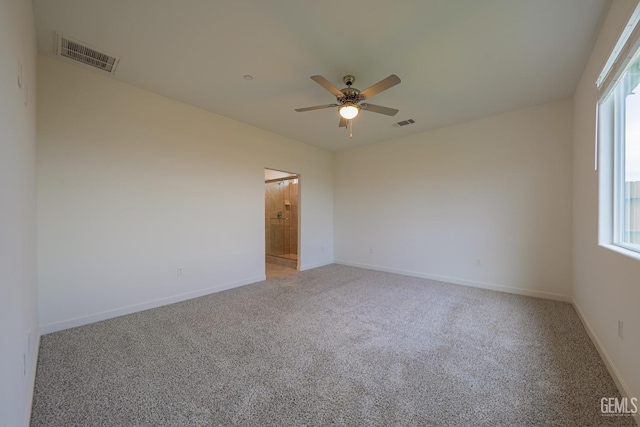 unfurnished room featuring ceiling fan and carpet floors