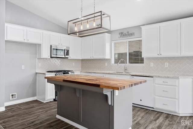 kitchen featuring white cabinetry, sink, stove, white dishwasher, and lofted ceiling