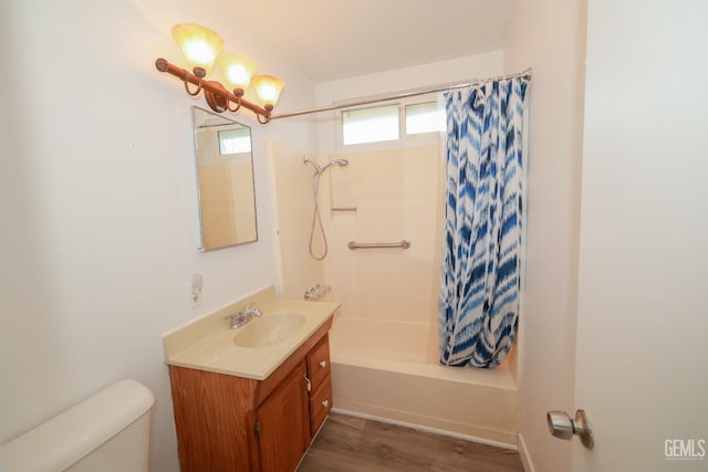 full bath with wood finished floors, vanity, toilet, and shower / tub combo with curtain