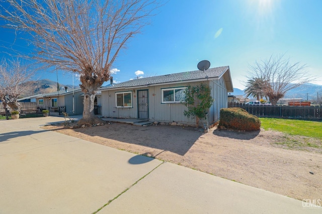 ranch-style home with fence