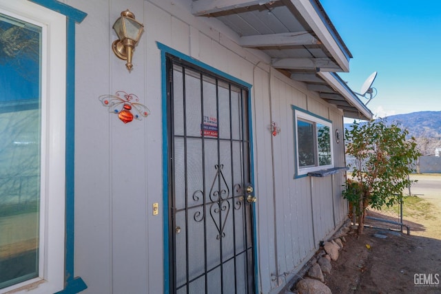 view of exterior entry with a mountain view