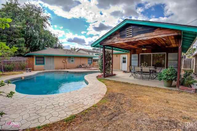 view of swimming pool with ceiling fan and a patio area