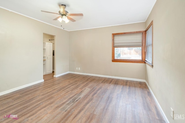 unfurnished room featuring hardwood / wood-style floors, ceiling fan, and crown molding