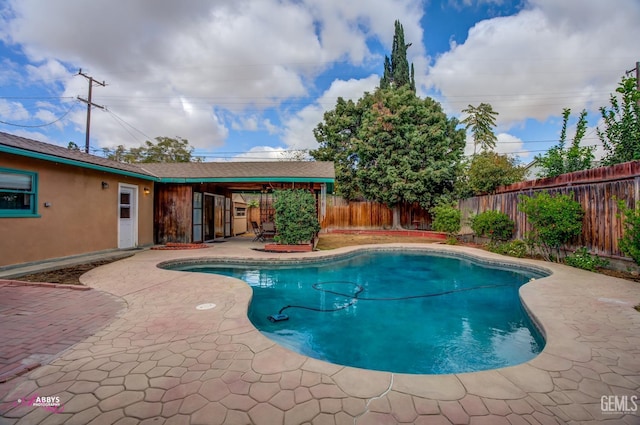 view of swimming pool featuring a patio