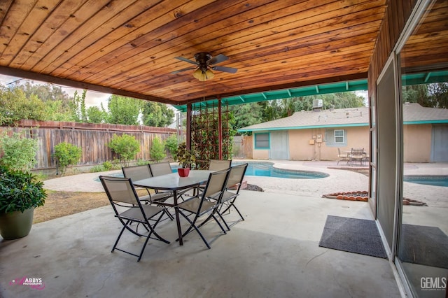 view of patio / terrace with a fenced in pool and ceiling fan