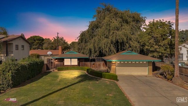 view of front of property featuring a lawn and a garage