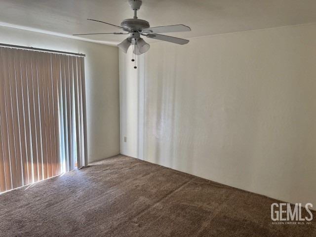 spare room featuring carpet floors and ceiling fan