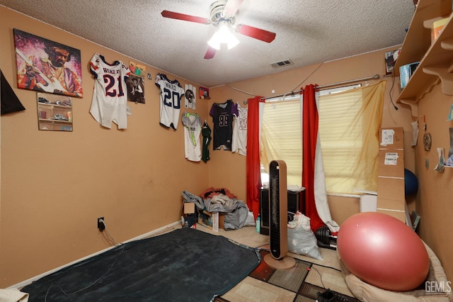 44827 Rock Island Dr, Lancaster, CA 93535 - workout area featuring a ceiling fan and a textured ceiling