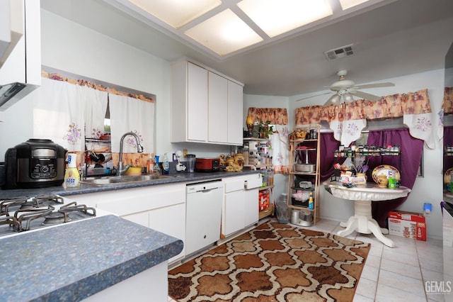 44827 Rock Island Dr, Lancaster, CA 93535 - kitchen with white dishwasher, light tile patterned flooring, white cabinets, a ceiling fan, and dark countertops