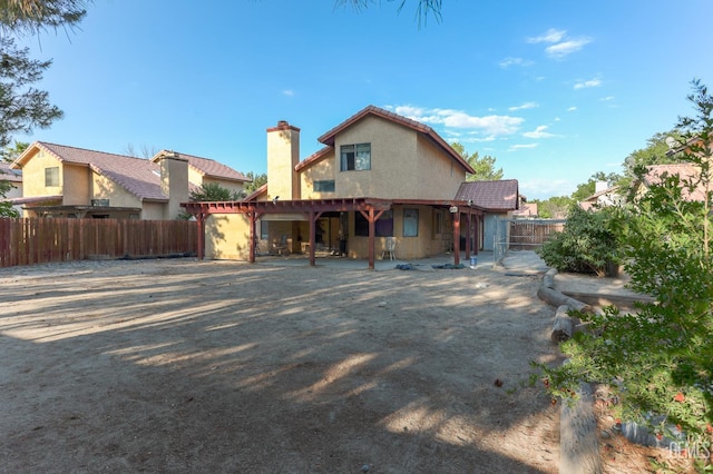 44827 Rock Island Dr, Lancaster, CA 93535 - rear view of house featuring a fenced backyard, a chimney, stucco siding, and a patio