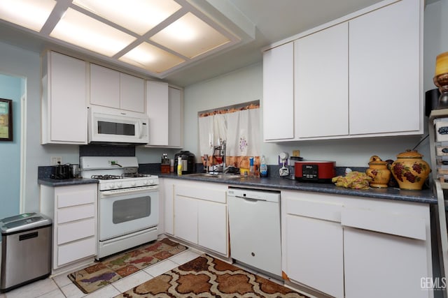 44827 Rock Island Dr, Lancaster, CA 93535 - kitchen featuring white appliances, dark countertops, and white cabinetry