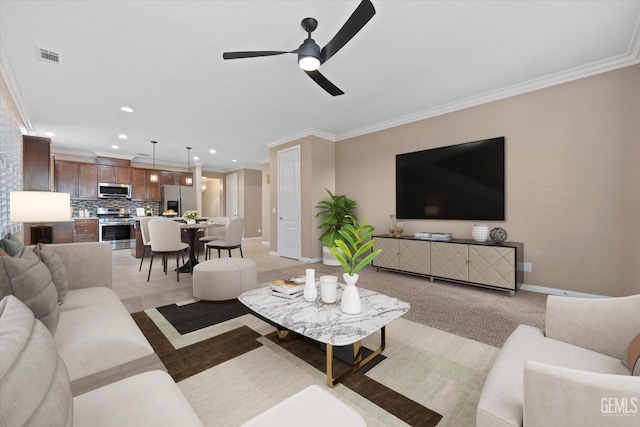 living room with crown molding and ceiling fan