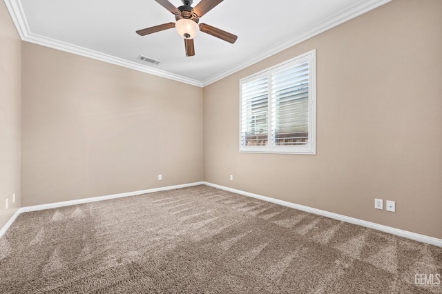 carpeted spare room featuring visible vents, baseboards, ornamental molding, and a ceiling fan