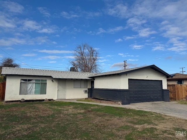 ranch-style house featuring a garage and a front yard