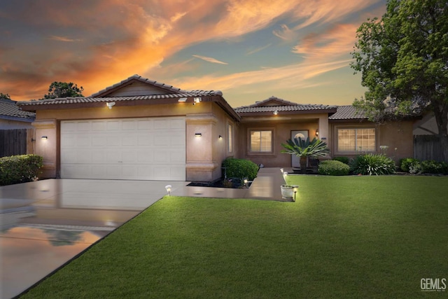 5211 San Mateo Dr, Bakersfield, CA 93307 - view of front of house with a tiled roof, concrete driveway, stucco siding, and a garage
