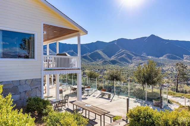 view of patio / terrace with a mountain view and a balcony